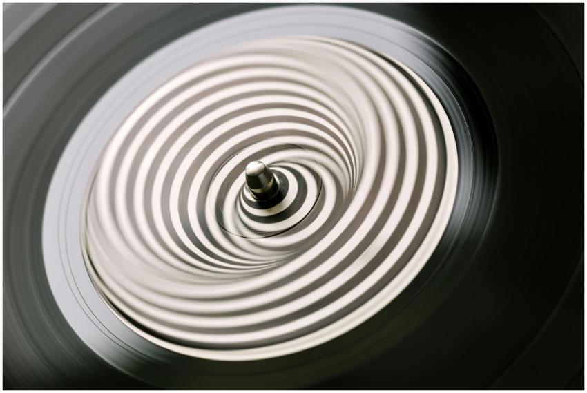 A close-up view of a vinyl record spinning, creati