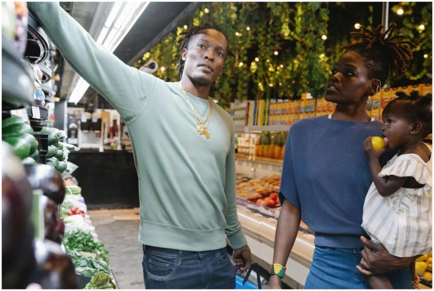A family shopping for fresh produce in a grocery s