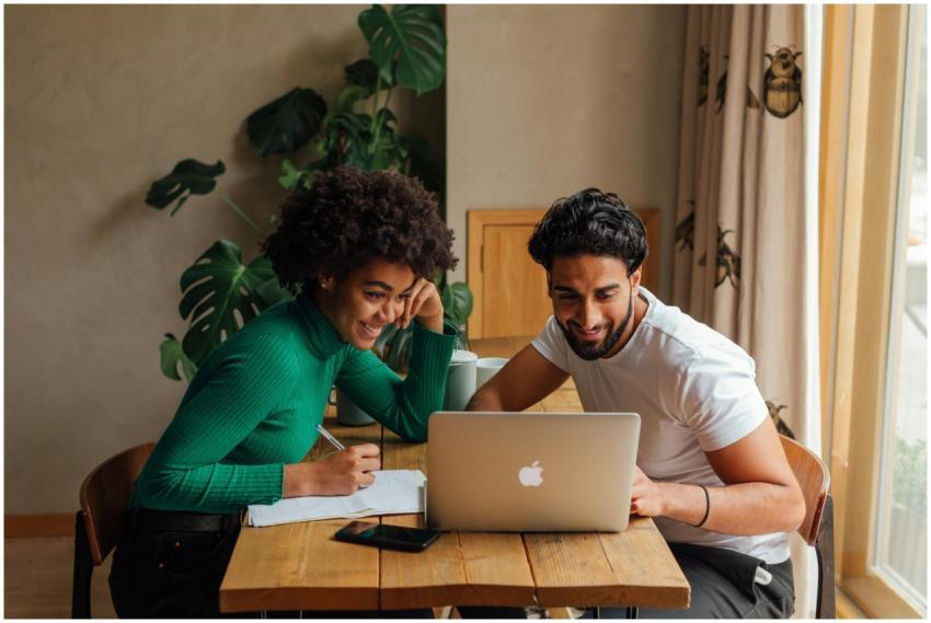 Two colleagues collaborate enthusiastically over a