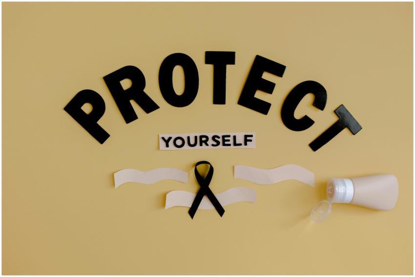 Black ribbon and lotion with 'Protect Yourself' on