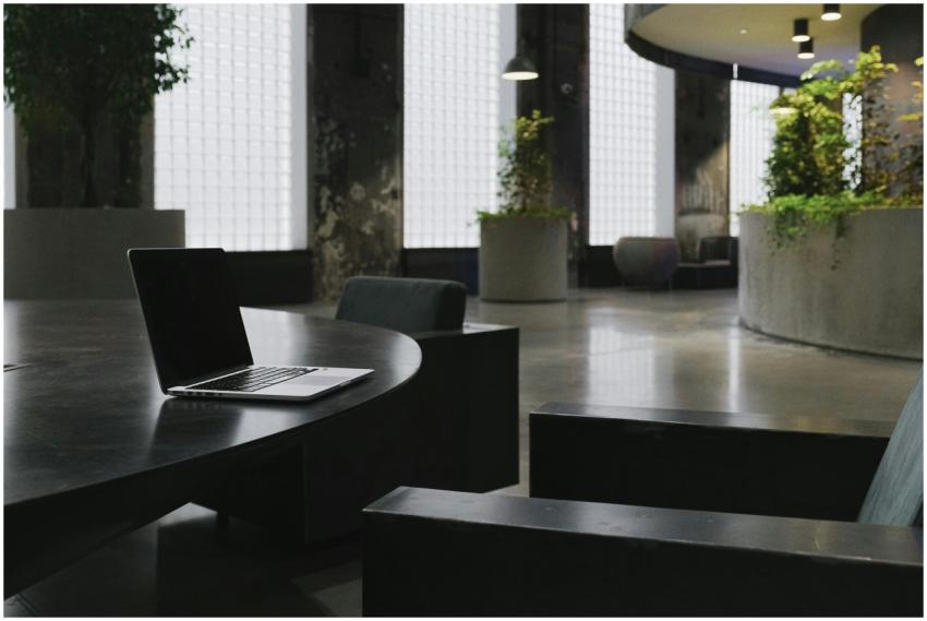 Minimalist office interior featuring a sleek lapto