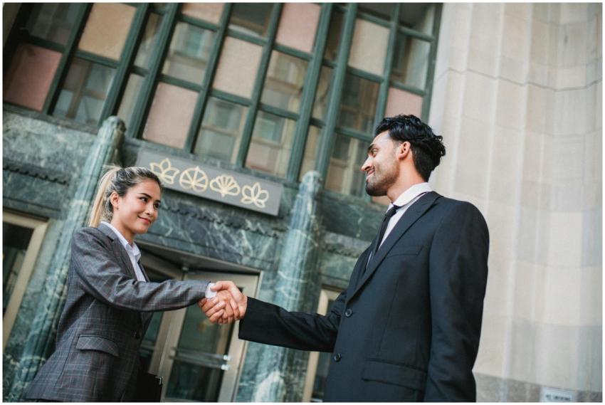 Two business professionals exchanging a handshake