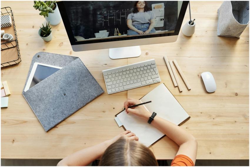 A teenager studying from home using a computer and