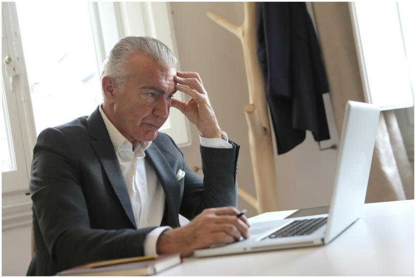 Senior businessman in office pondering work issues