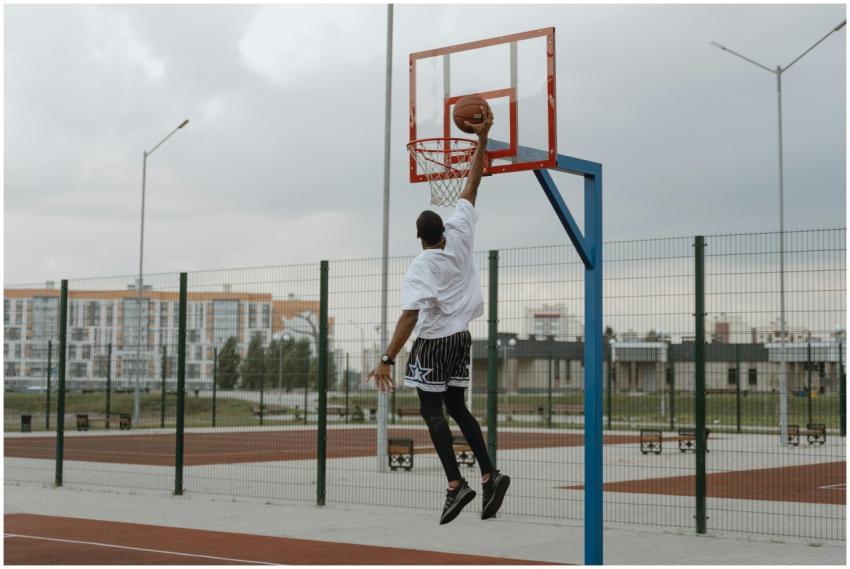Young man performing an impressive basketball dunk