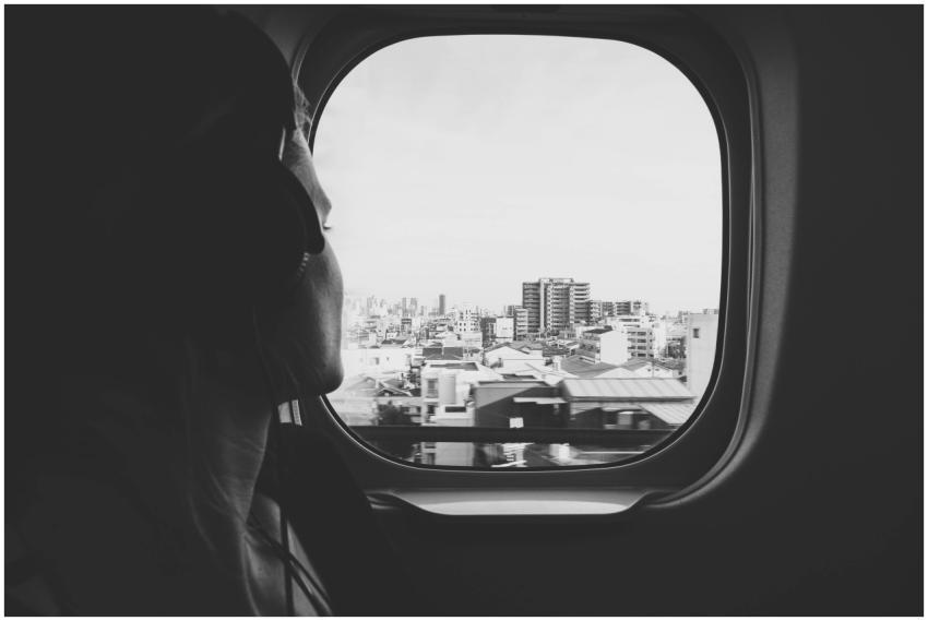 Black and white photo of a woman listening to musi