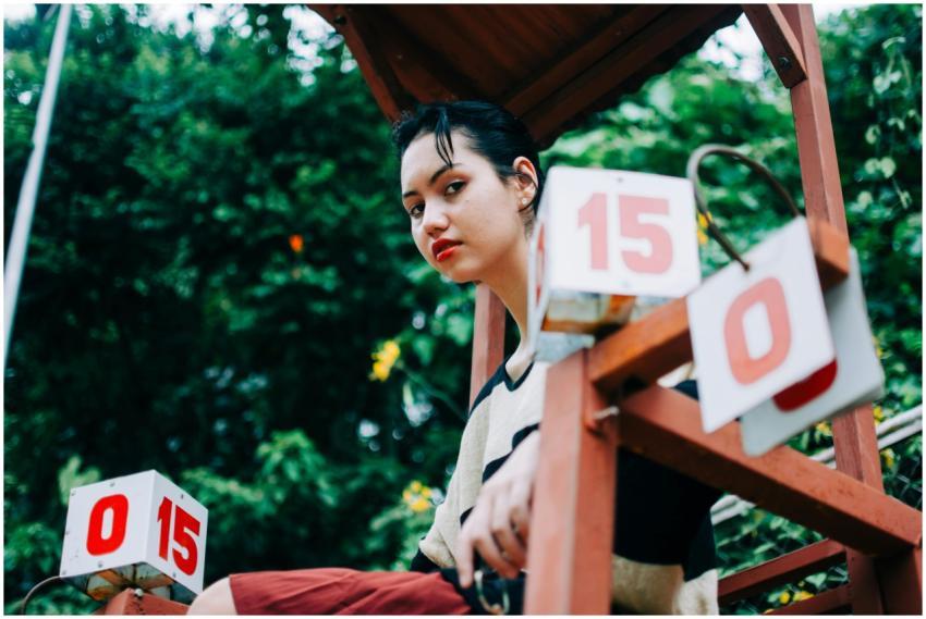 Low angle of serious female on chair with points f