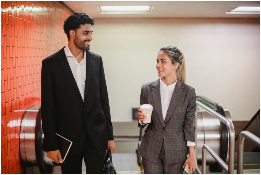 Two business professionals conversing indoors, dre