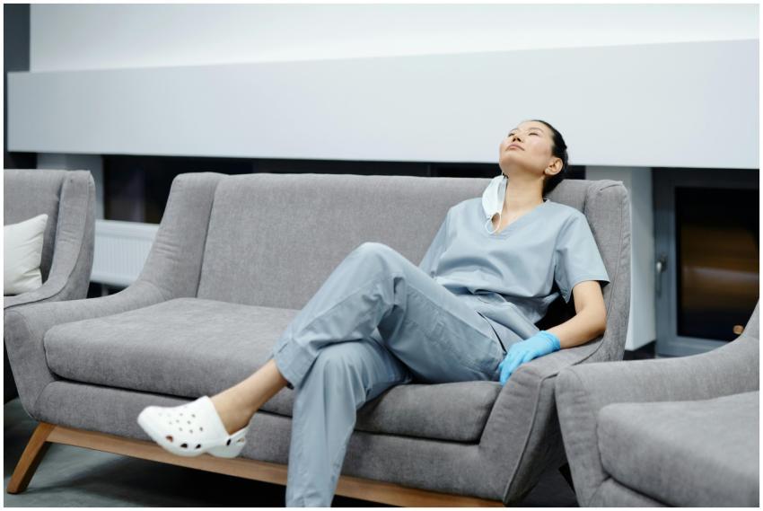 Nurse in scrubs takes a break, resting on a comfy