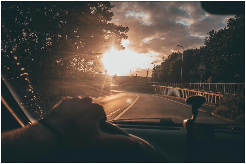 Capturing a serene drive at sunset, with a scenic