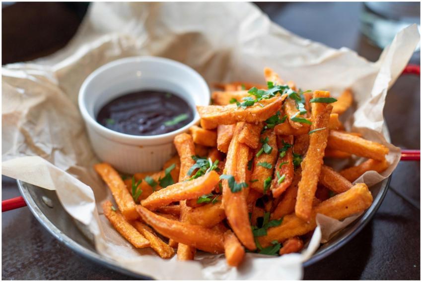 Close-up of crispy sweet potato fries garnished wi