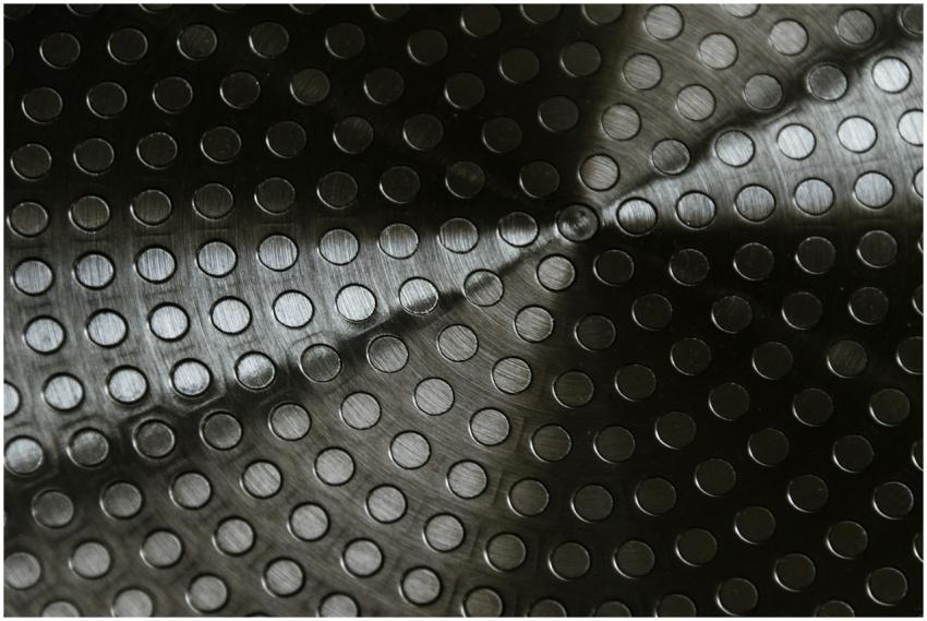 Close-up of a metallic surface with circular patte