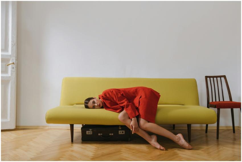 A woman in a red blazer rests on a minimalist yell