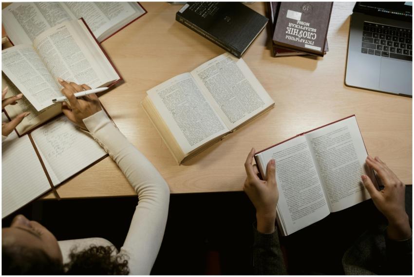 Group of adults studying together with open books