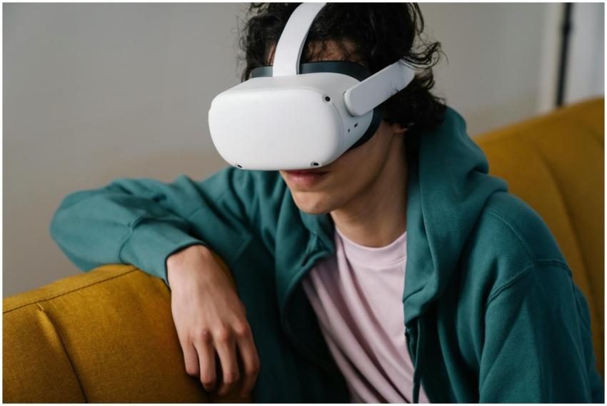 High angle of young male sitting on couch and expl
