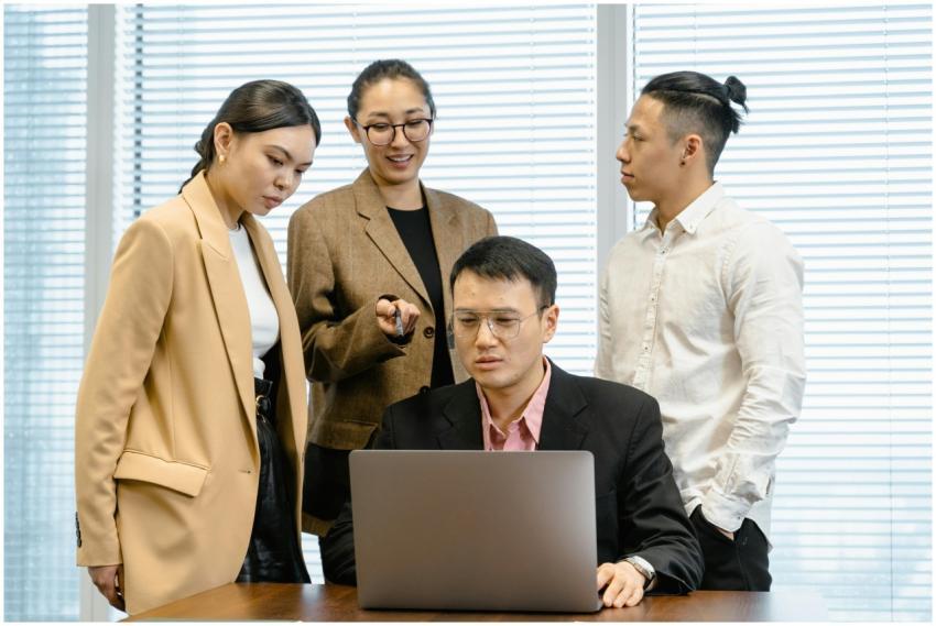 Group of colleagues in formal wear actively discus