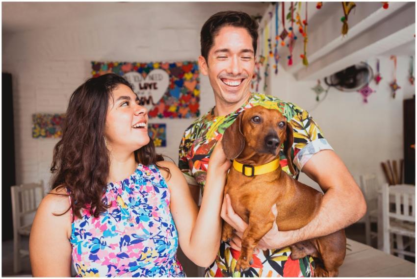 Joyful couple shares a moment with their dachshund