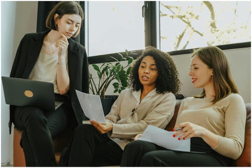 Three professional women engaged in a collaborativ