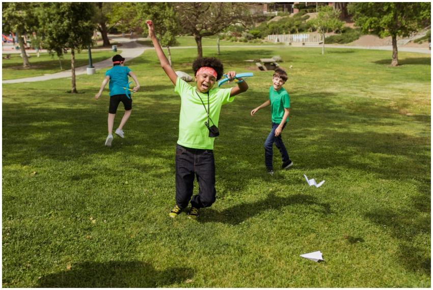 Kids having fun outdoors at summer camp playing wi