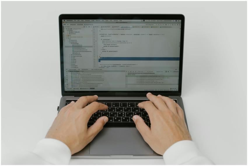 Close-up of hands coding on a laptop, showcasing s