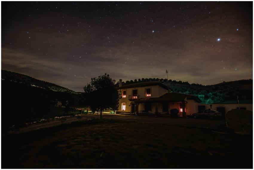 A serene landscape with a starry sky and a warmly