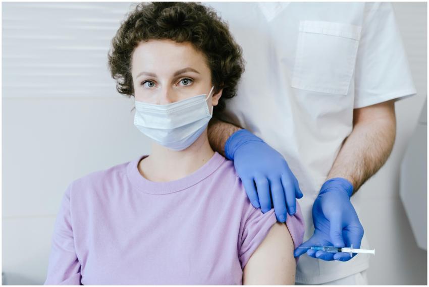 A healthcare worker gives a vaccine injection to a
