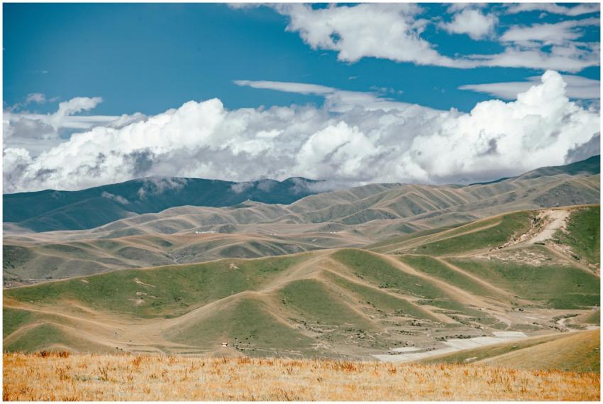 Expansive landscape with rolling hills under a vib