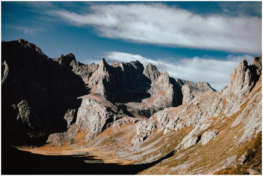 Dramatic mountain landscape with rugged peaks unde