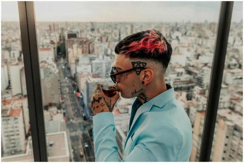 A fashionable person sipping fernet with a city vi