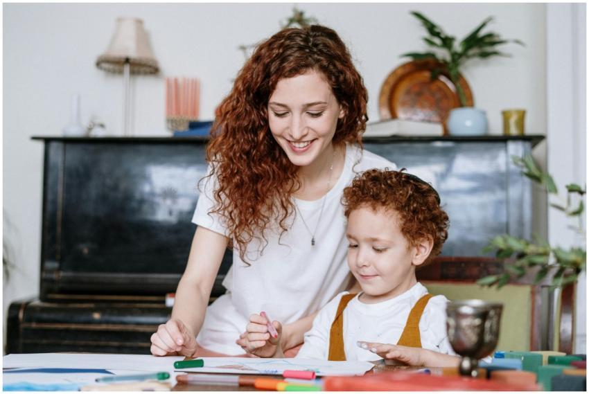 A mother and son enjoy a bonding moment indoors, c