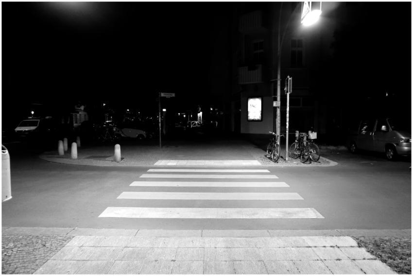 Nighttime street scene with illuminated crosswalk