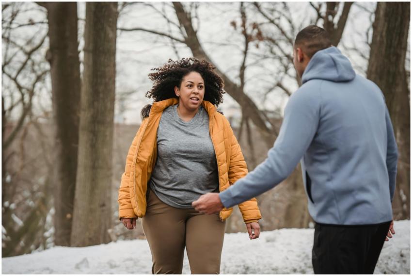 A couple enjoying a winter workout in a snowy park