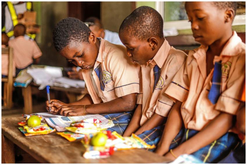 Children focused on writing and studying in a clas