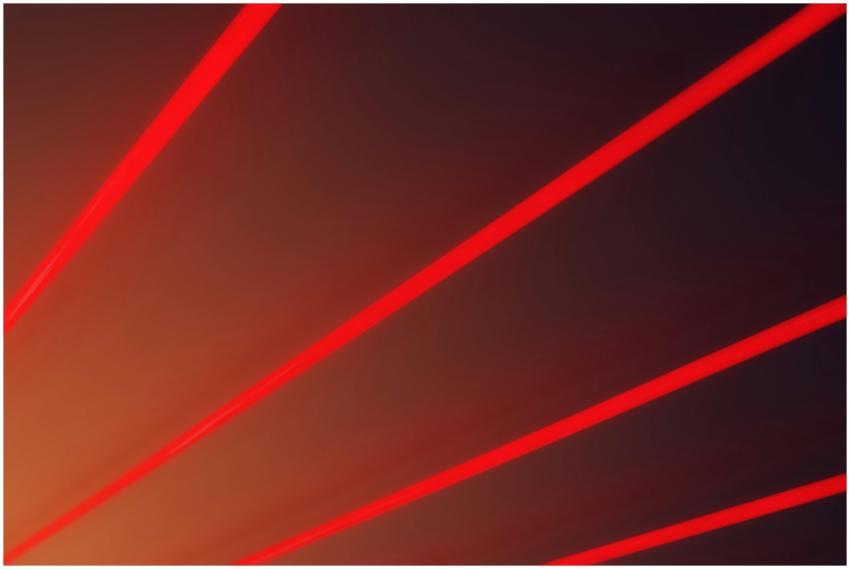 Abstract image with vibrant red laser beams on a d