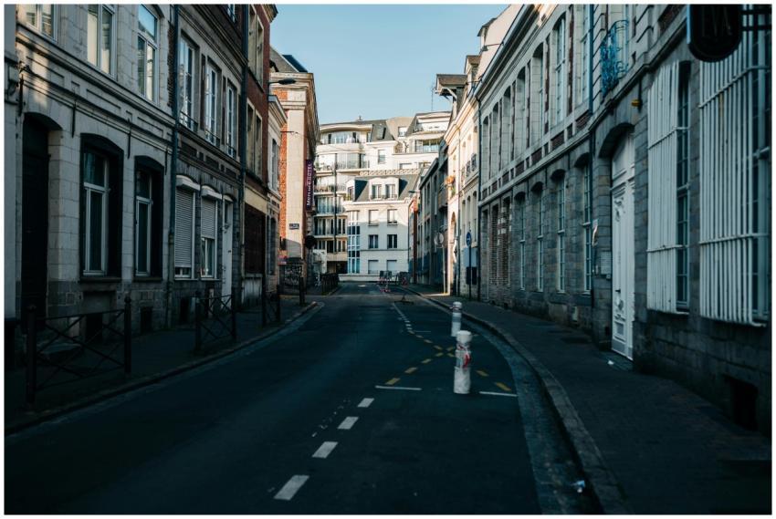 Empty alleyway flanked by historic buildings under