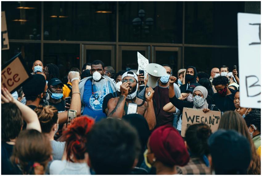 A diverse crowd at a protest for racial justice in
