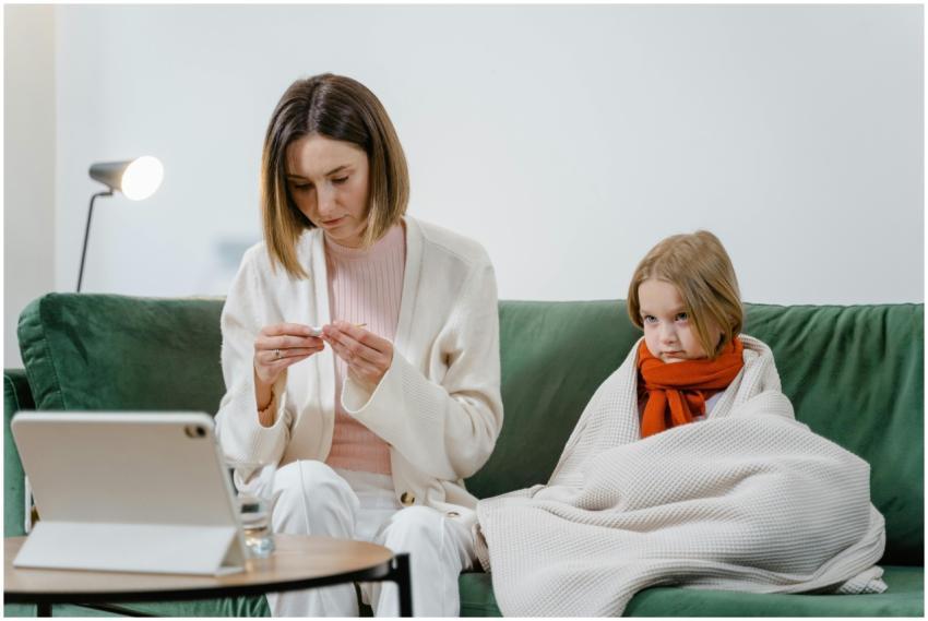 A mother and daughter engage in a telehealth sessi