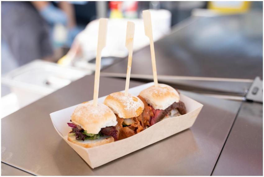 Appetizing mini burgers on skewers served in a pap