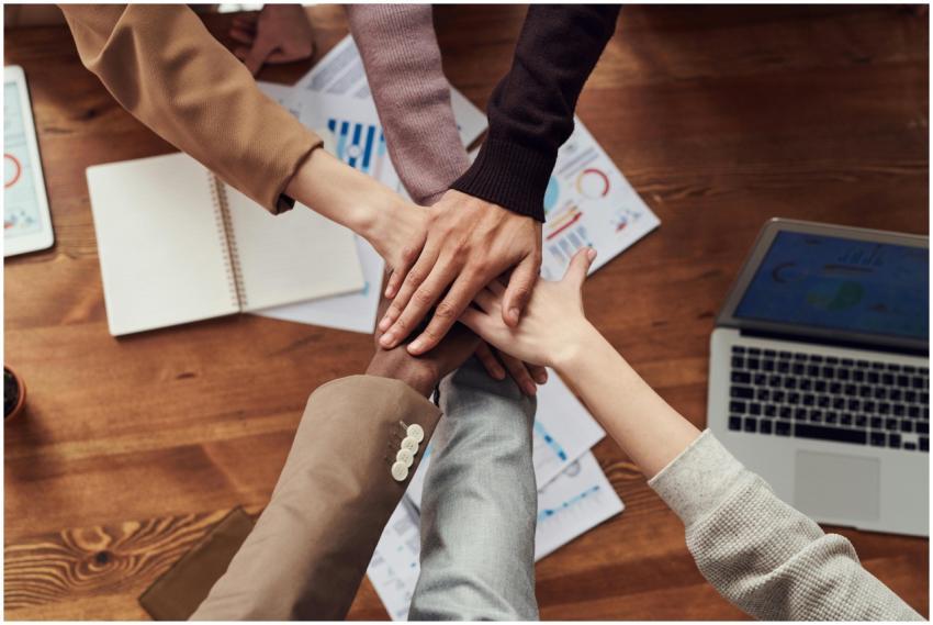 Diverse professionals unite for teamwork around a