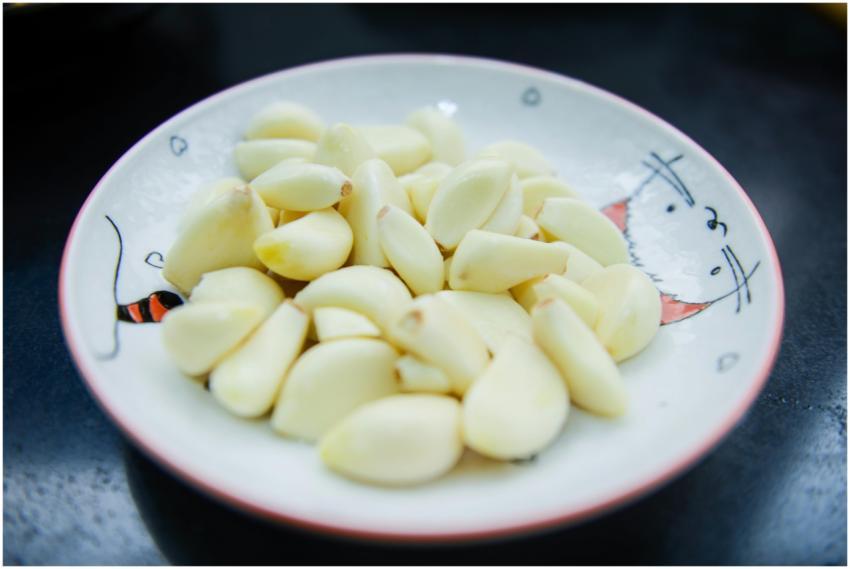 A close-up photo of peeled garlic cloves arranged