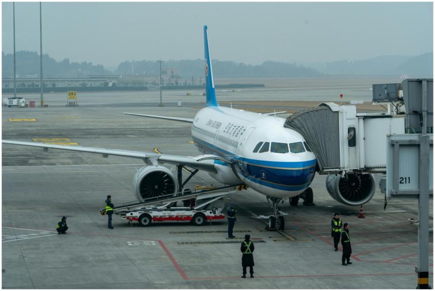 Passenger airplane docked at airport terminal with