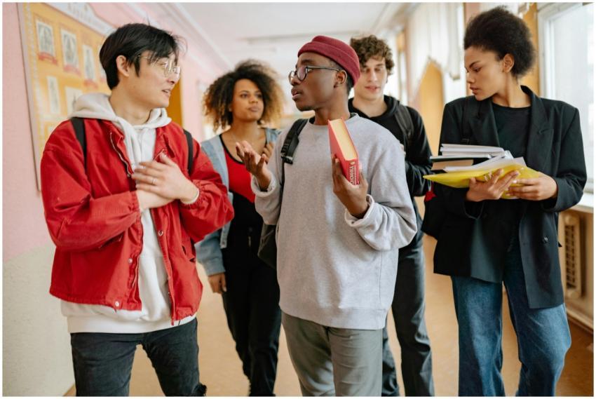 A group of diverse students walking and talking in