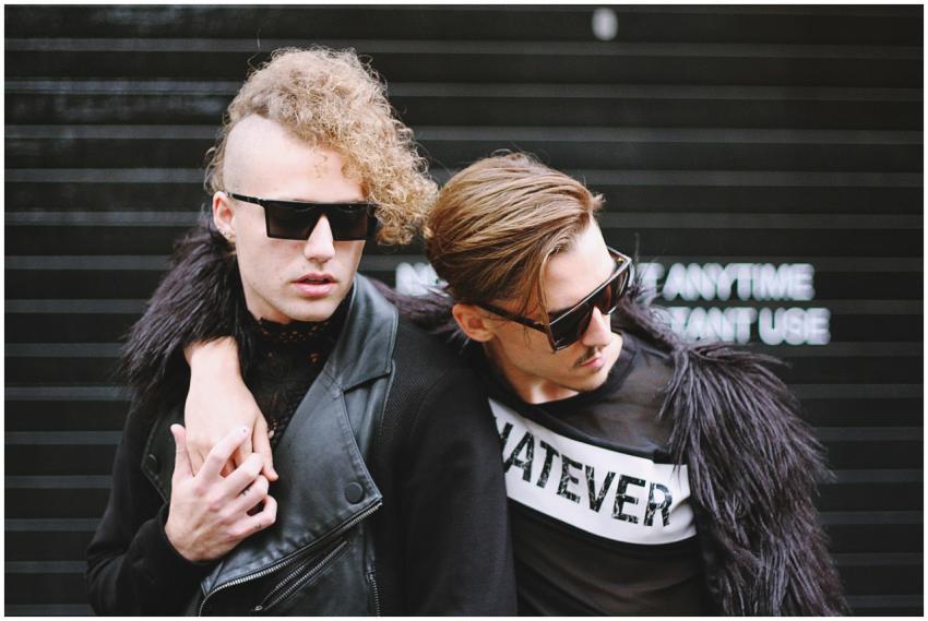 Stylish couple showcasing bold street fashion in L