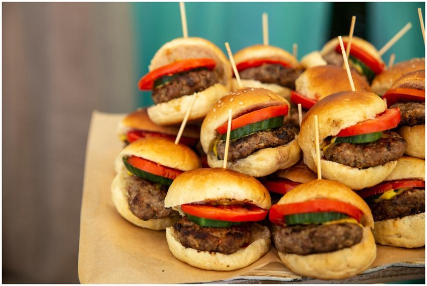 A tempting platter of mini burgers with fresh toma