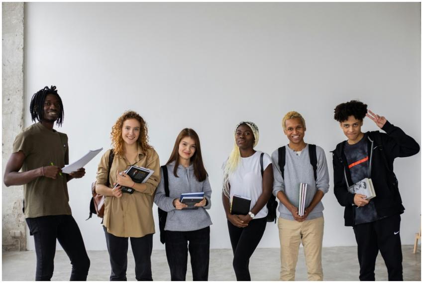 Group of smiling multiracial classmates standing w