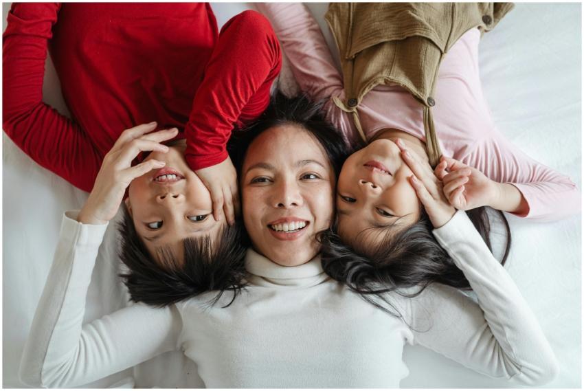 Mother and two children laughing and bonding while