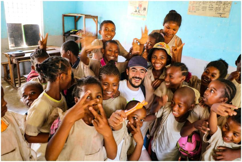 A group of smiling students in a lively classroom