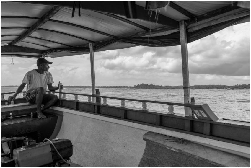 A man sits on a boat in Moreré, Brazil, captured i