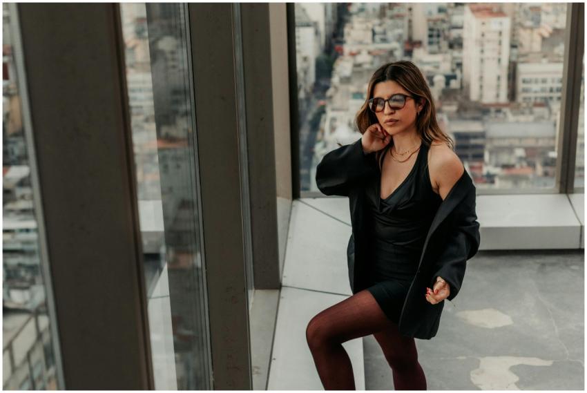 Fashionable woman in black with city backdrop in B