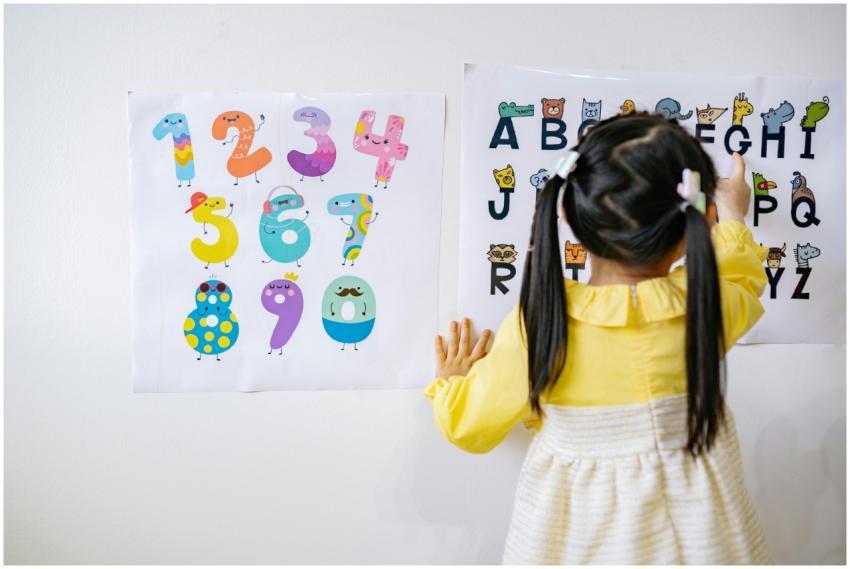 Young girl in kindergarten learning numbers and al
